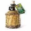 Extra virgin olive oil D.O.P. in bottle covered with straw