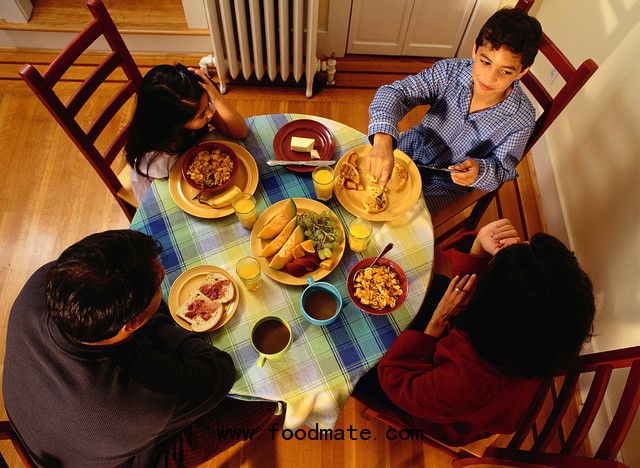 Family of four eats around the table